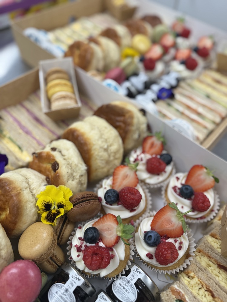 Brunch spread of sandwiches, granola and fresh fruit