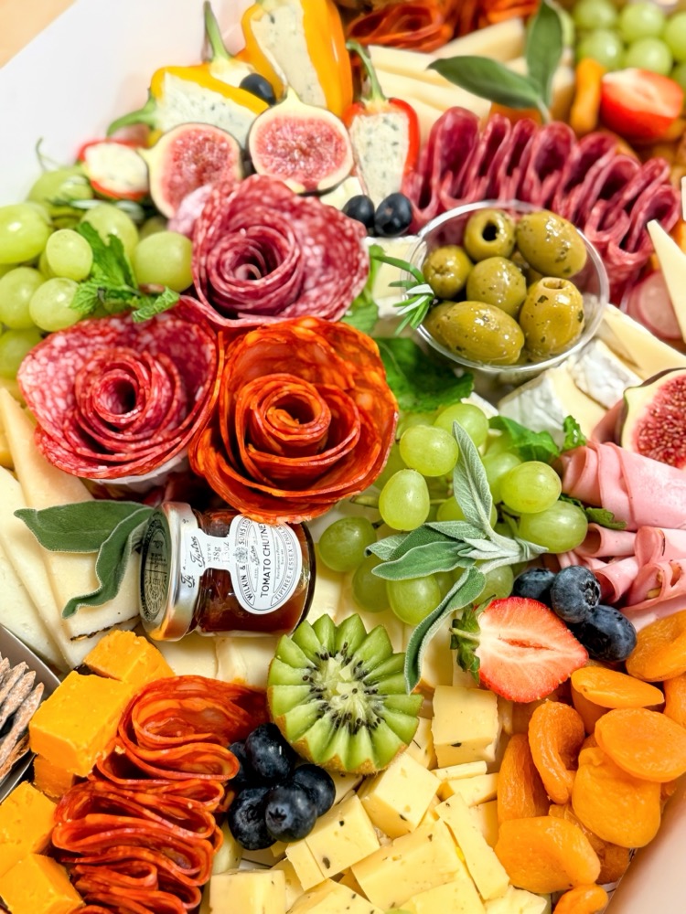 Charcuterie board with salami roses, cheese and fruit