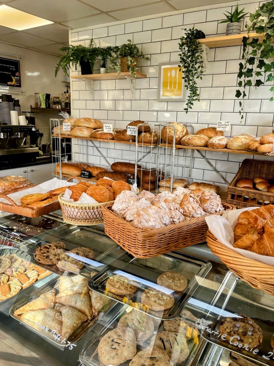The Happy Toast counter, with sourdough loaves on the shelves and pastries and cookies in the display case